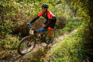 Visit 44 Mountain biker takes a turn through a puddle at Pleasant Grove in Fluvanna County