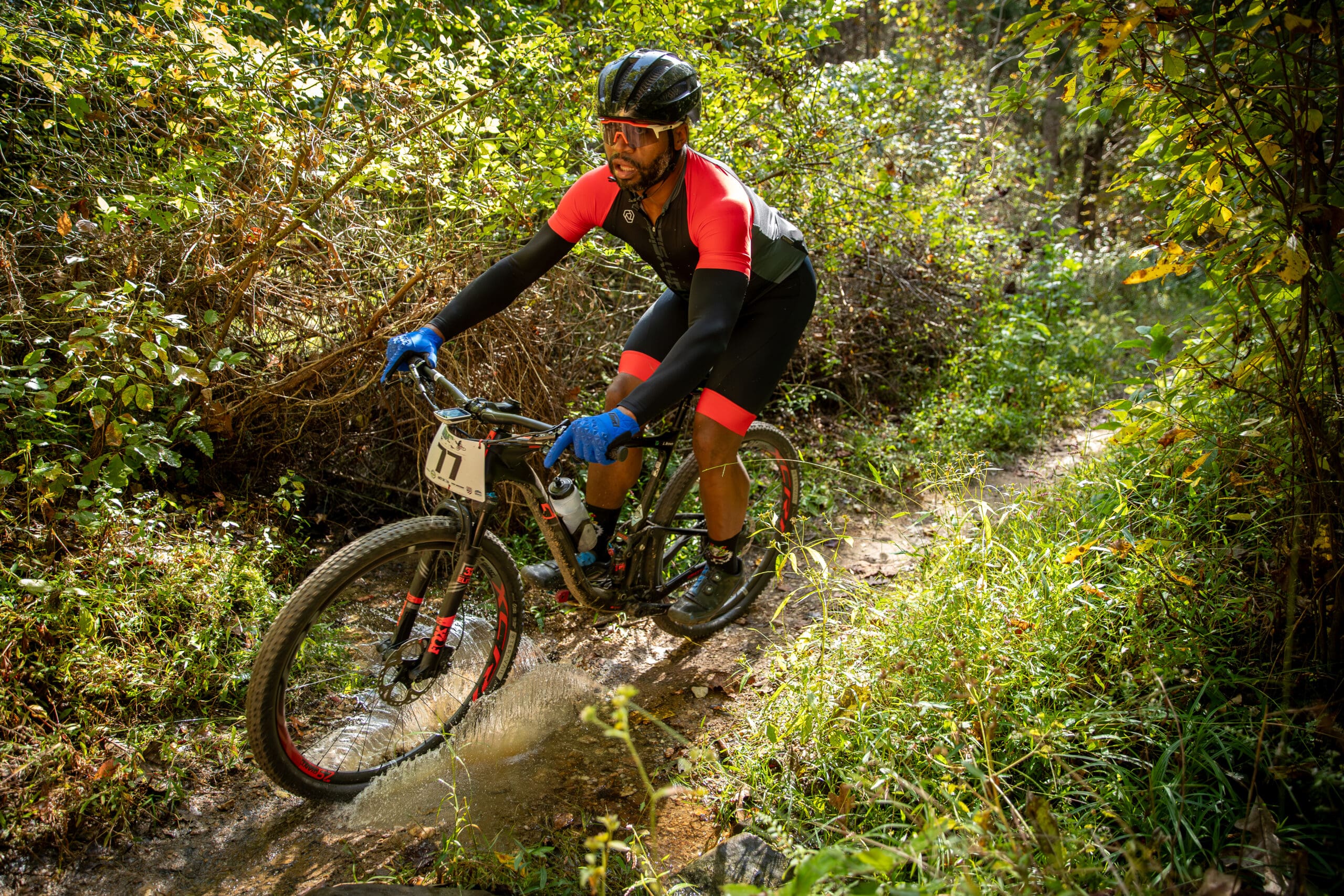 Mountain biker takes a turn through a puddle at Pleasant Grove in Fluvanna County